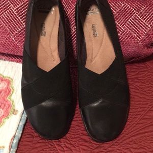 Black leather slip on shoes. Like a loafer